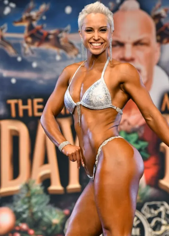 A Mutate Labs client competing on stage in the bikini division